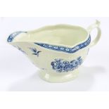 An 18th century Worcester porcelain sauce boat painted in underglaze blue with floral sprays and