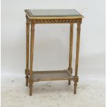 A French giltwood glass topped side table with bergère caned undertier and fluted tapering legs,