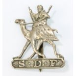 A hallmarked silver Sudan Defence Force cap badge with later brass bar to reverse, Birmingham 1930,