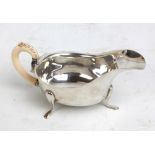 VINER'S LTD; an Edward VIII hallmarked silver sauce boat with shaped rim and ivory c-scroll handle,