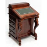 A reproduction mahogany leather inset Davenport with eight short drawers to interior and four