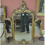 An ornate gilt framed triptych mirror with pierced pediment.