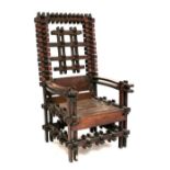 An unusual oak chair, possibly for purposes of restraint with slatted back and lower section,