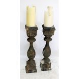 A pair of rustic pine candle stands, height of each approx 84cm.
