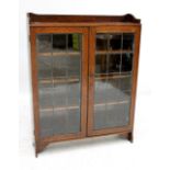 An oak leaded glass freestanding bookcase.