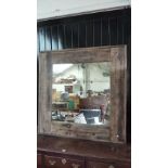 A large rustic pine wall mirror, 136 x 136cm.