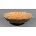 JOHN DUNN (born 1944); a raku bowl covered in fluorescent pink crackle glaze, painted JD mark,