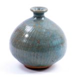 KATHARINE PLEYDELL-BOUVERIE (1895-1985); a fluted stoneware bud vase covered in blue/grey glaze,