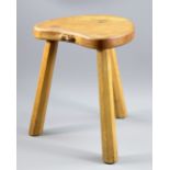 MOUSEMAN; a Robert Thompson oak stool with shaped seat raised on three octagonal supports,