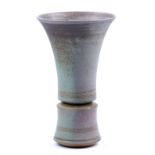 PHIL MUMFORD (born 1945); a flared stoneware vase covered in mottled green and pink glaze,