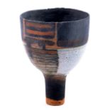 ROBIN WELCH (born 1936); a stoneware cup on tall pedestal decorated with bands of bronze and grey,