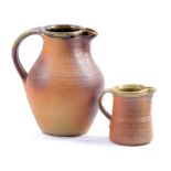 Muchelney Pottery; two stoneware jugs, impressed pottery marks, tallest height 17.5cm (2).