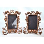 A pair of early 20th century copper photo frames with open frame and wirework stylised floral and