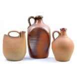 Muchelney Pottery; two stoneware flagons and a flask, impressed pottery mark to flask,