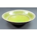 JOHN DUNN (born 1944); a large raku bowl covered in fluorescent green crackle glaze,