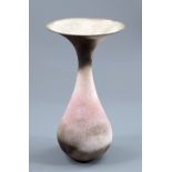 JUDY TRIM (1943-2001); a bulbous white earthenware vase with flared rim, smoke-fired pink,