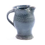 WALTER KEELER (born 1942); a salt-glazed jug with splayed foot, height 14cm.