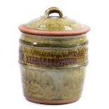 RICHARD BATTERHAM (born 1936); a stoneware jar and cover, green ash glaze, height 26cm.