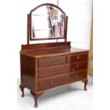 An early 20th century mahogany mirror-back dressing chest, two frieze drawers over two long drawers,