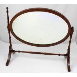 A Victorian walnut swing dressing table mirror, turned supports on cross-stretcher (af).