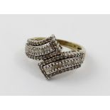 A 9ct yellow gold and diamond cross-over ring set with two rows of baguette-cut stones within a