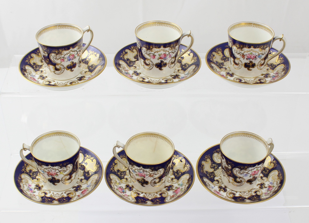 A cased set of six Royal Crown Derby tapering demi-tasse cups and saucers decorated with floral