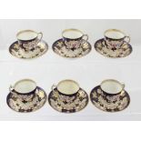 A cased set of six Royal Crown Derby tapering demi-tasse cups and saucers decorated with floral