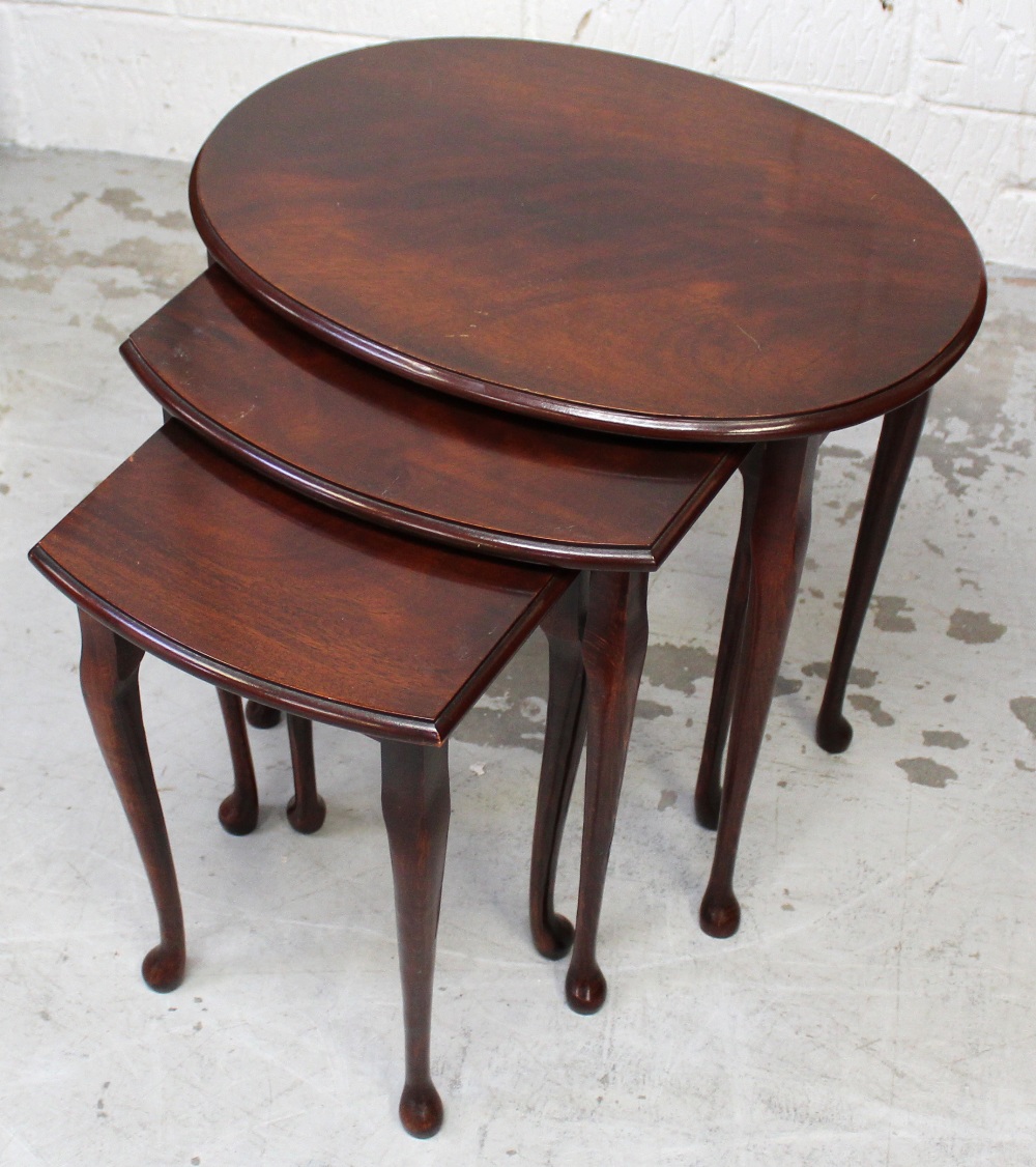 A nest of three mahogany tables, tapering cabriole supports and pad feet, length 57cm.