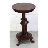 A William IV style circular mahogany table on turned support to lower stepped circular base,