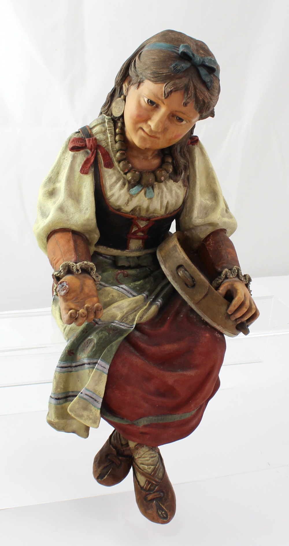 A 19th century Bretby 'Gypsy Girl' figure with a blue bow in her hair,