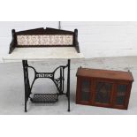 An Edwardian red walnut wall cabinet with central glazed door opening to reveal shaped shelves,