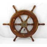 A tropical hardwood six spoke ship's wheel with brass hub, diameter 67cm.