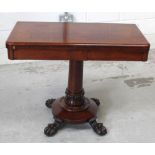 A Victorian rosewood fold-over card table, central column support and circular base to paw feet,