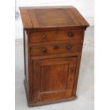 A Victorian oak clerk's desk with hinged top above dummy drawer and one working drawer above