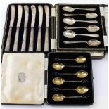 A set of six hallmarked silver coffee spoons with interlocking diamond-shaped terminals and gilded