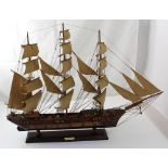 A scratch-built model of an 18th century frigate or brigantine, with sails and presented on stand,