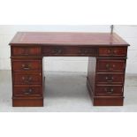 A mid-20th century mahogany kneehole desk with faux leather insert,