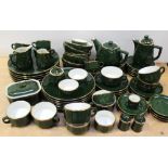 A quantity of 'Apilco' French dinner and teaware, bottle green ground and gilt-heightened,