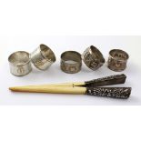 A set of Chinese silver-mounted ivory glove stretchers and five white metal Eastern napkin rings