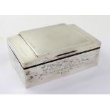 A George V hallmarked silver Art Deco shaped two-division cigarette box with engine-turned