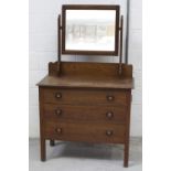 An early-to-mid 20th century oak mirror-back dressing chest with Art and Crafts style copper