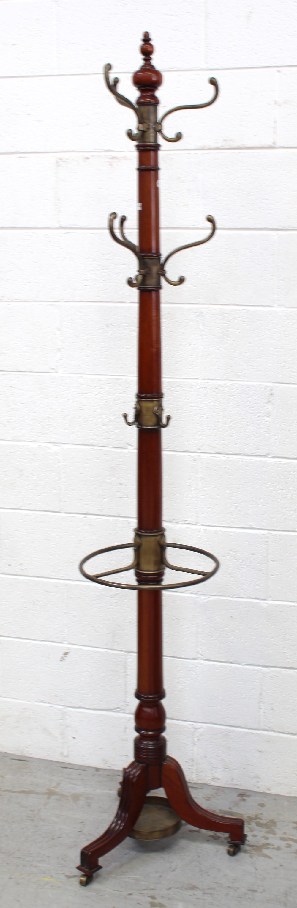 A 20th century Regency-style mahogany hall tree with brass umbrella stand,