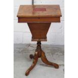 A Victorian walnut sewing box with silk inlaid cartouche to the top, to tripartite supports,