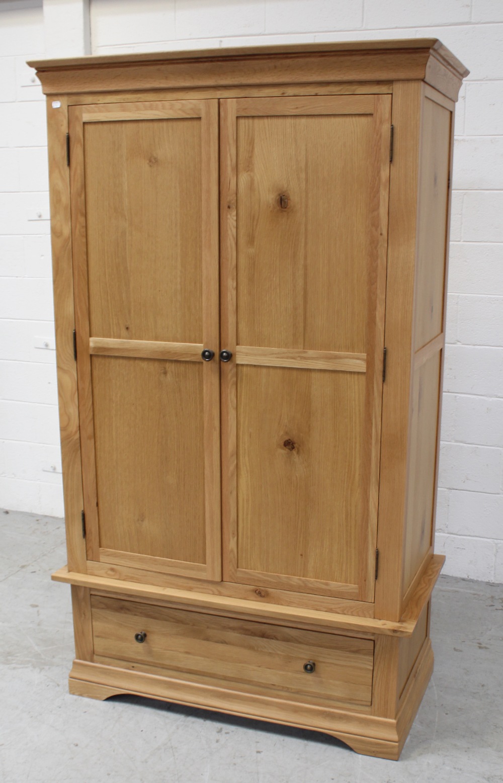 A modern light oak two-door wardrobe on single-drawer base, 192 x 108cm.