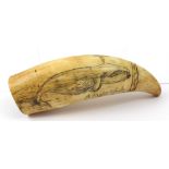 A late 19th century scrimshaw whale tooth, later carved with whaling scene,