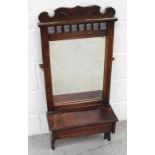 An Edwardian walnut wall-mounted shaving mirror with bobbin-turned gallery to the top and lidded