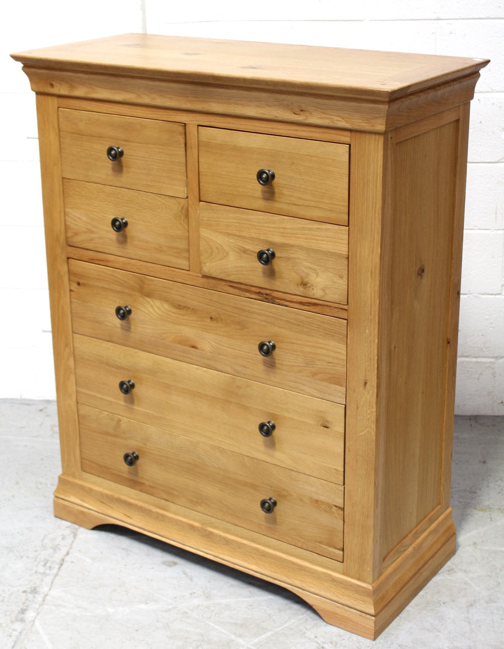 A modern light oak chest of four-over-four drawers, 120 x 98cm.