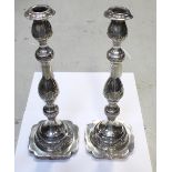 A pair of George V hallmarked silver baluster form candlesticks with chased swags and berries