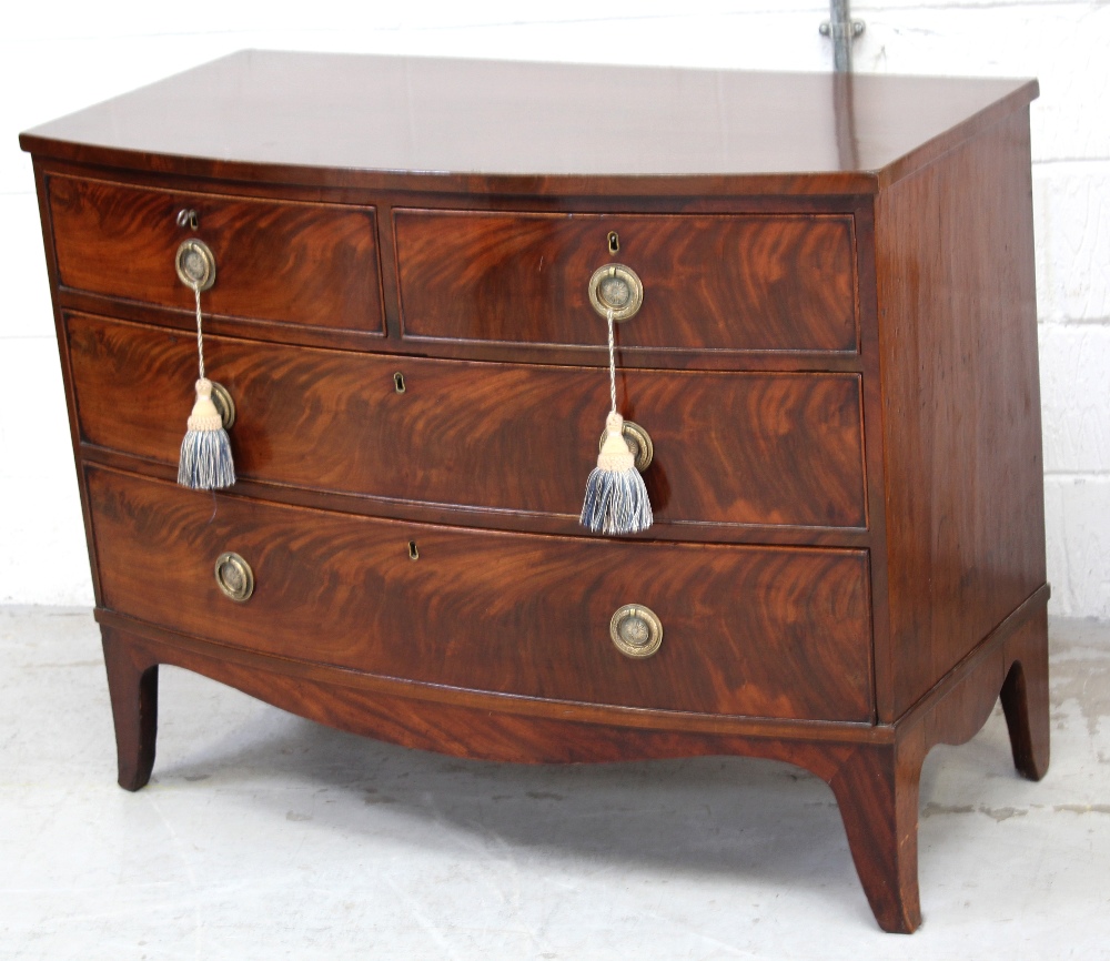 A George III bow-front chest, two drawers over two lower drawers, to splayed bracket supports,