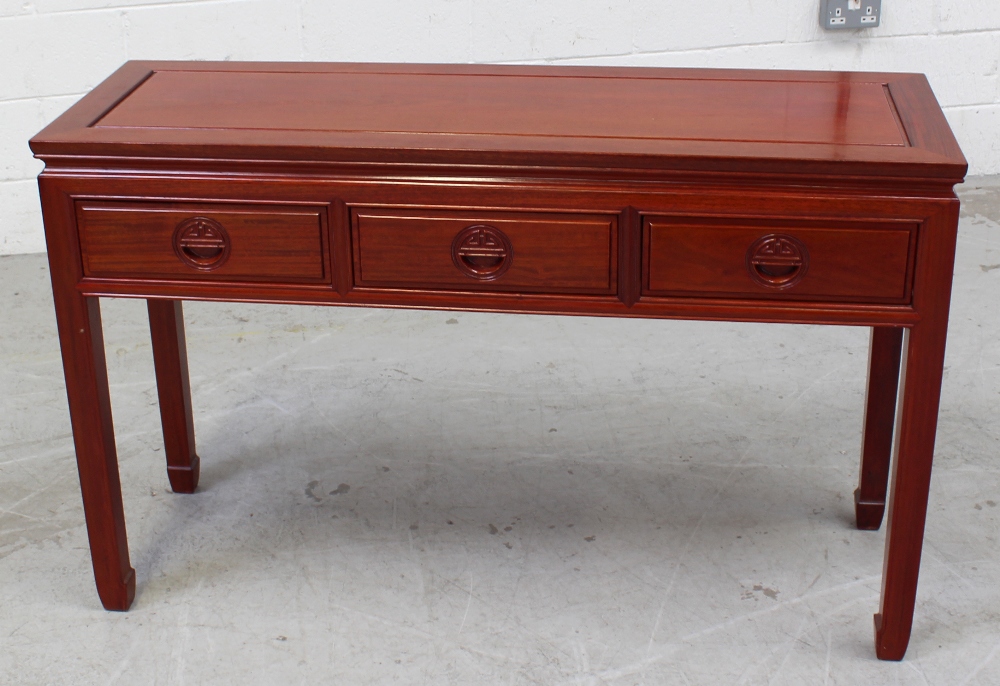 A contemporary Chinese hardwood hall table with three drawers, width 122cm.